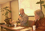 Photo of Xiaoshi Xing, with Chunzhen Liu, conducting a colloquium on observed climate change impacts.
