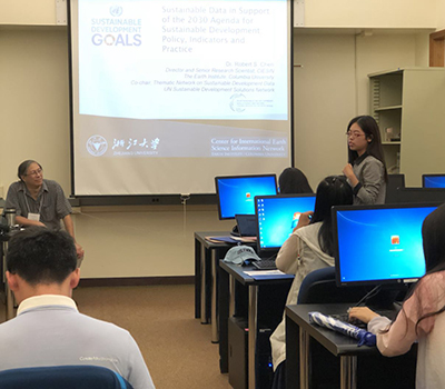CIESIN director Robert Chen, left, listens to a student speak following his presentation at a summer seminar on environmental policy and sustainable development for students from Zhejiang University in Hangzhou, China.