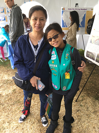 Lisa Lukang, CIESIN information specialist, with her daughter Isabelle, as they visit the CIESIN tent at the day-long Lamont Open House October 13.